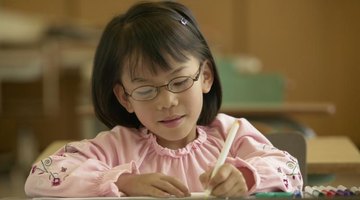 Elementary school student drawing with markers.
