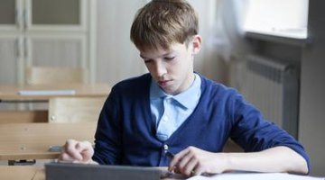 A student using a tablet computer in the classroom.