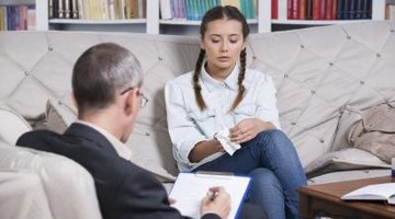 A counselor in a session with a young female patient