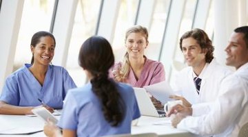 Group of nurses and doctors sitting around a table