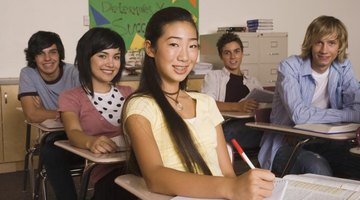 Smiling middle school student taking notes in class