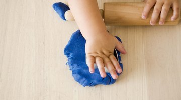 Modeling dough and clay encourage fine motor development.