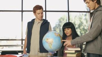 Students looking at globe in class