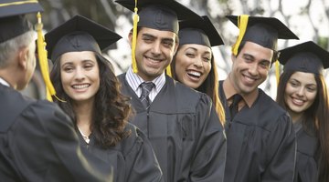 A group of college graduates recieving their diplomas at their graduation ceremony