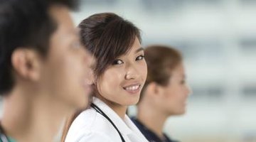 Young medical student smiling in lab coat