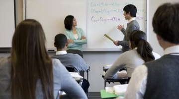 School boy giving presentation in front of class.