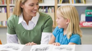 Teacher smiling next to kindergartener