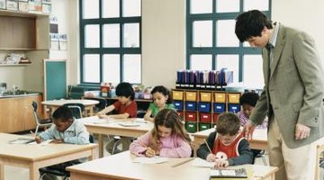Teacher checking on students' work in classroom.
