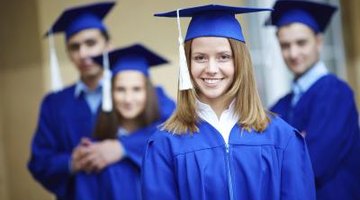 Smiling college graduates in blue robes