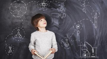 A student standing in front of a chalkboard.