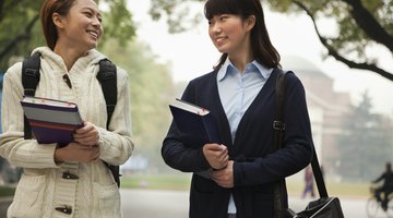 College students holding their textbooks.