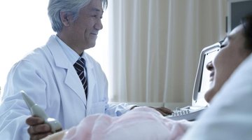 A doctor using an ultrasound to examine a pregnant woman.