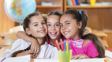 Portrait of three girls in the classroom.