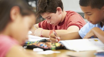 Children reading at school table.