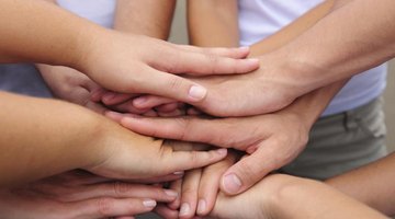 Close-up of youth stacking hands on top of each other.