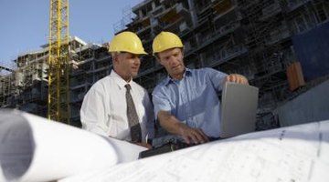 Construction managers oversee operations at a building site.