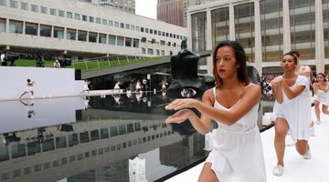 A high school troupe performing at an event promoting peace.