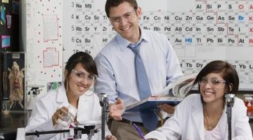 Science teacher helping his students.