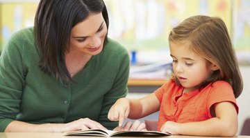 Elementary school student reading for teacher.