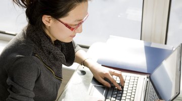 College student typing on laptop