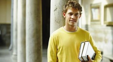 Student holding books on campus.