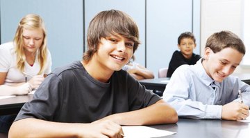 Smiling middle school students sitting at tables