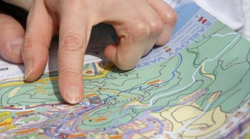 Close-up of hand pointing to map
