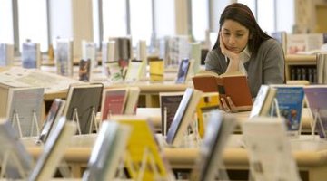 High school student reading in school library