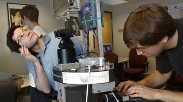 Two college students work on an engineering project.