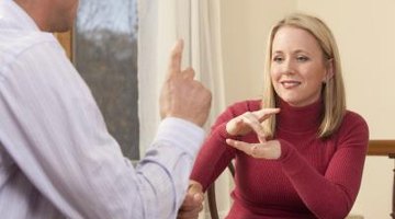 Adults practicing sign language