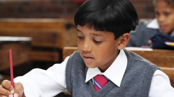 Fourth grade student writing at desk.