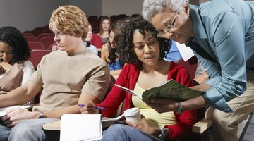 Professor showing course catalog to student in lecture hall