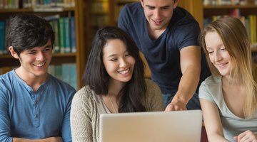 Students working on laptop in library