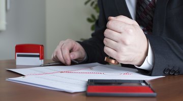 Man's stamping official documents.